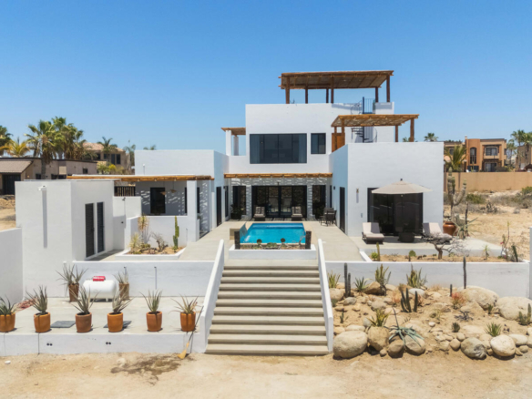 Chileno Bay El Posito We are excited to introduce Casa Elisabeth, an amazing, newly constructed custom home in the private El Posito area of Todos Santos. Located just three rows back from the beach, this three-bedroom, three-full and two-half bathroom residence offers every amenity desired for a tropical paradise. The downstairs features an open-concept living room, dining room, and a fully stocked kitchen with brand-new appliances, including a dishwasher. The main floor also includes a laundry room and an outdoor water feature with a professionally designed rock wall. The principal bedroom downstairs offers a unique indoor/outdoor bathroom with two showers and an outdoor bathtub.Each of the three bedrooms includes an en-suite bathroom with double vanities. The upstairs bedroom features its own private furnished terrace and access to one of four large patios, complete with a bar area and outdoor furniture perfect for enjoying ocean sunsets. Additionally, a shaded third-floor observation deck provides panoramic ocean and mountain – Casa Elisabeth, Pacific, Pacific, BS